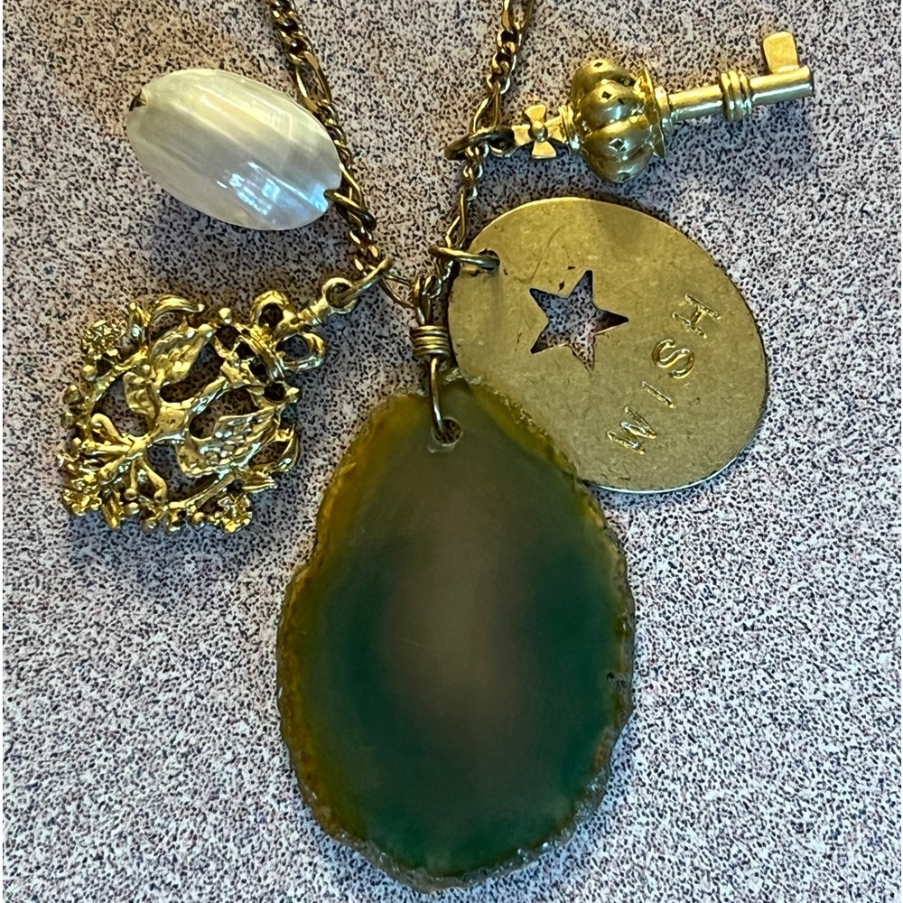 Vintage gold tone necklace with green/yellow agate accompanied by 4 charms.